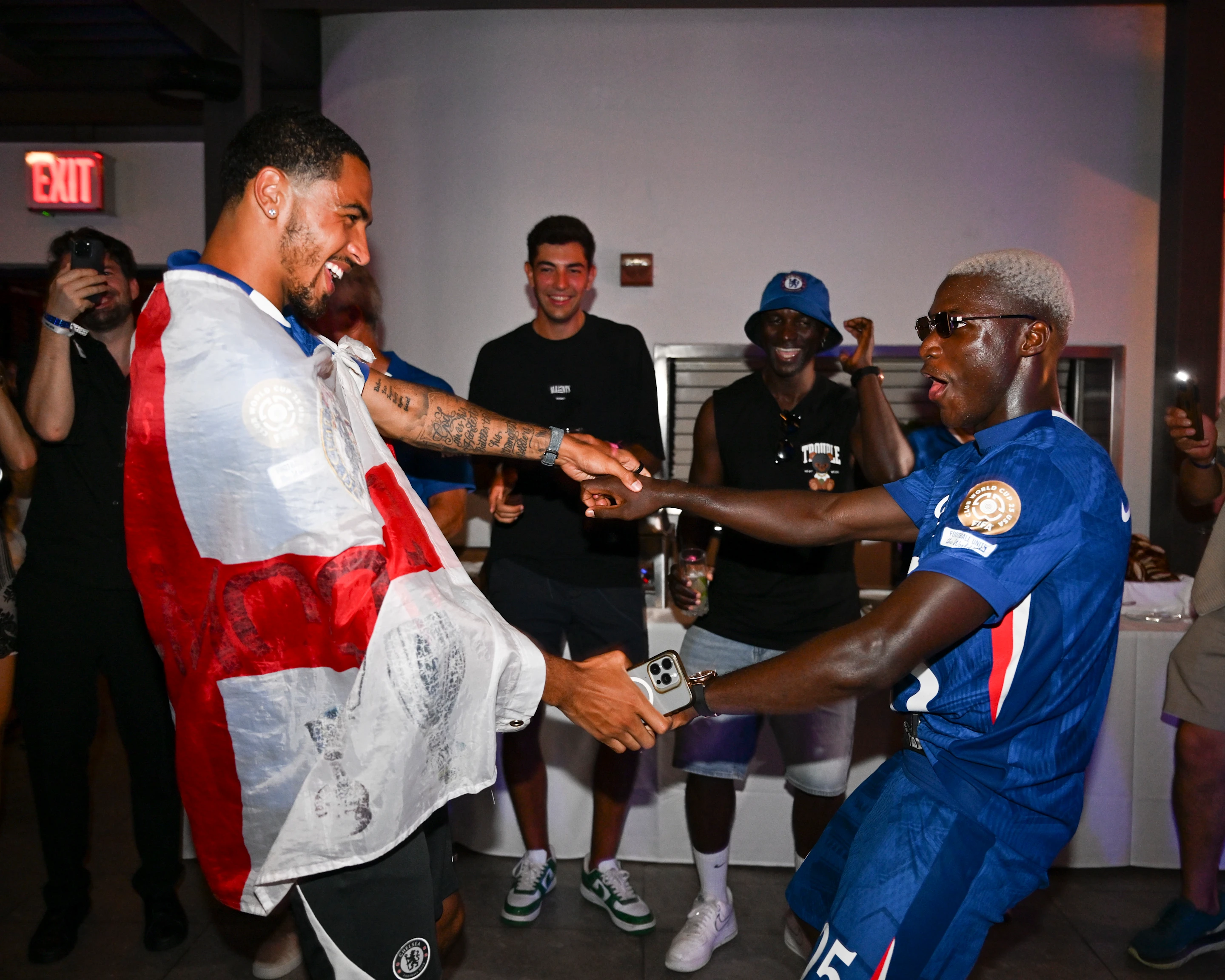 Elite football after-party energy in a private hospitality room